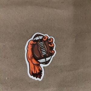 monster hand catching an American football. 